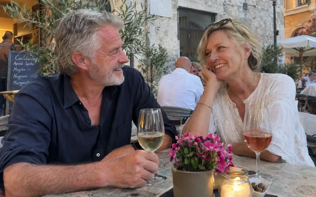Couple over 50 enjoying a relaxed outdoor café date