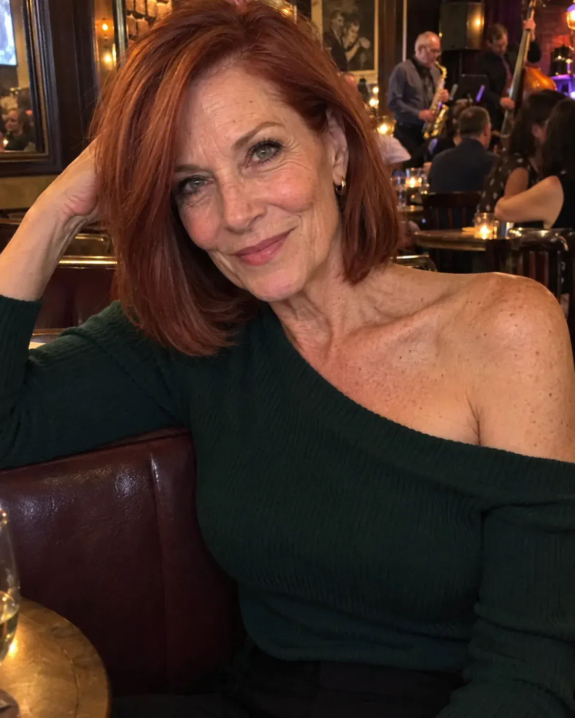 Red-haired woman wearing green in a jazz bar